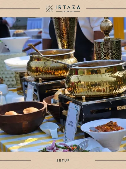 A daytime buffet setup for a home party, featuring my golden chafing dishes on a cheerful yellow and white striped tablecloth. This shows how I can create a bright and festive mood for any celebration.
