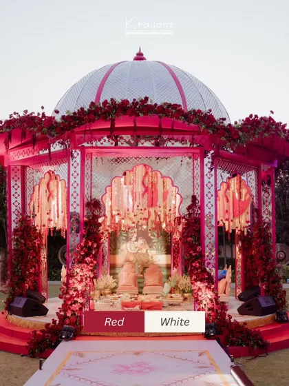 A bold and beautiful mandap design using a striking red and white color palette. The dome structure, adorned with roses, makes a powerful statement while remaining rooted in tradition.