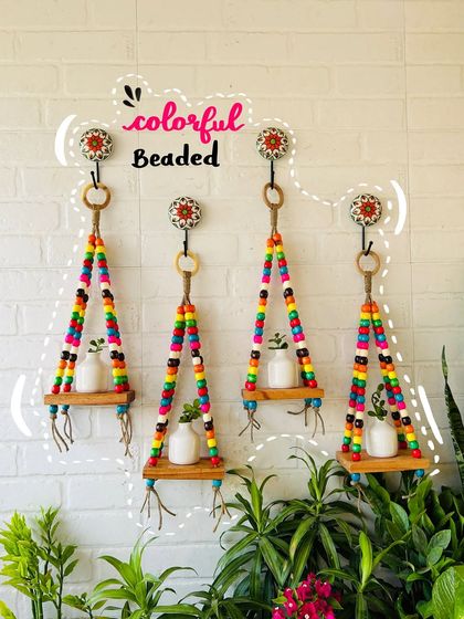 Get a 'Pinterest-worthy' look with our colorful macrame beaded wall shelves. Made with vibrant wooden beads and natural jute, these shelves are perfect for displaying small ceramic bottles or your favorite mini plants, adding an aesthetic touch to your balcony.