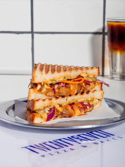 The Togarashi Chicken Melt sandwich, perfectly stacked to show off its colourful layers of slaw and chicken.