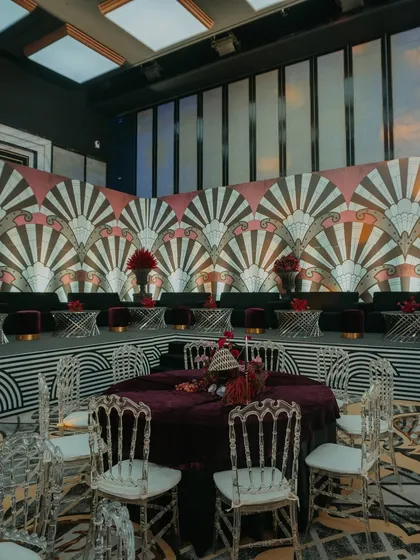 An Art Deco-themed Sangeet with a bold, geometric backdrop and plush plum-colored seating. This setup is perfect for a chic, modern, and glamorous evening.