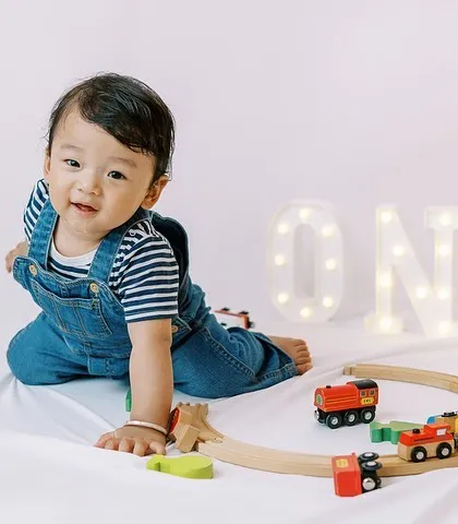 For the little boy who loves trains. We incorporated his favorite toy into his first birthday shoot, making it personal and fun for him.