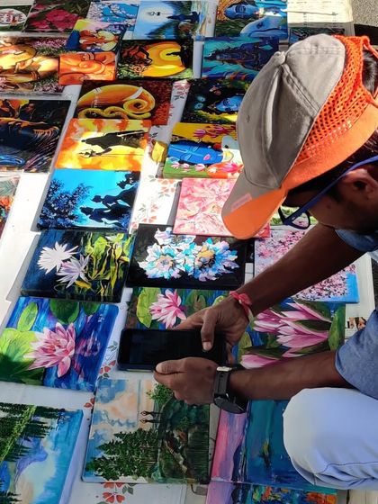 My collection of tiny paintings spread out at Chitra Santhe, attracting art admirers of all ages. These small canvases are a great way to start your art collection.