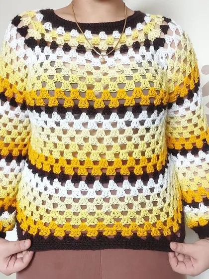 A classic granny stitch sweater is a cozy wardrobe essential. I created this piece with a vibrant, striped color scheme and balloon sleeves, but I can customize the colors and fit to match your personal style perfectly.