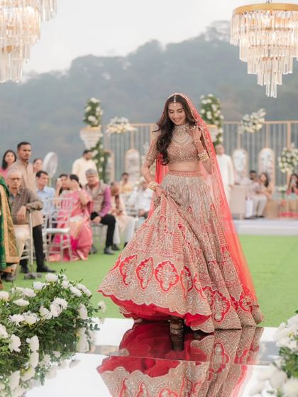 The bride twirls on the mirrored aisle, her reflection adding a magical quality to this joyful bridal entry shot.