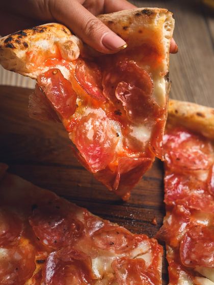A perfect slice of our Truffle Salami pizza. The combination of savoury salami and earthy truffle is a match made in heaven.