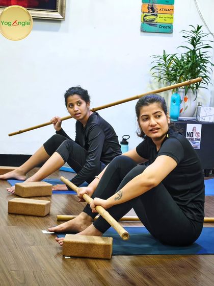Our Stick Yoga classes are both challenging and fun. Here, students use bamboo sticks to assist with posture and alignment, often leading to moments of intense focus mixed with lighthearted discovery.