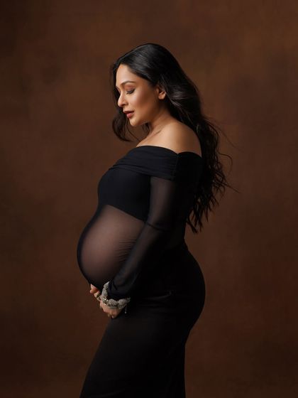 A classic profile shot that beautifully and tastefully showcases the baby bump through the sheer fabric.