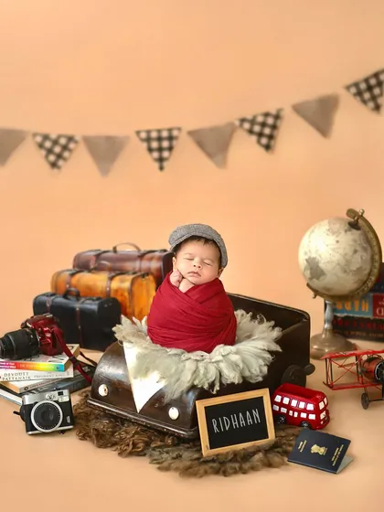 A travel-themed newborn shoot for a little boy named Ridhaan, which means "to travel." We surrounded him with globes, vintage cameras, and a passport.