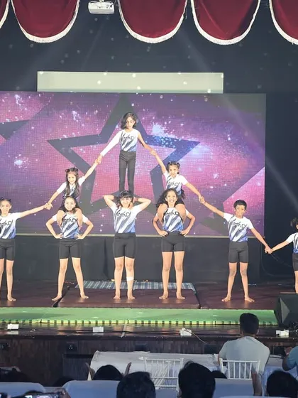 This star formation is a crowd favorite, showcasing how our gymnasts work together. It's a perfect example of the group activities we practice to build unity and create a spectacular show.