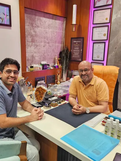 A consultation is a deep dive into your life's blueprint. Here, I am sitting with a client, discussing his handmade numerology report. My focus is always on providing clear, practical guidance that you can actually use to see a real benefit in your life.