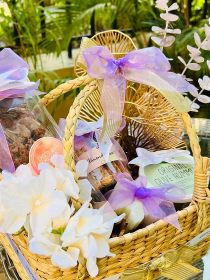Customization is at the heart of what I do. This hamper was designed around a specific lilac and lavender color palette requested by a client, combining gourmet cookies, hummus, and almond biscotti in a beautifully coordinated arrangement.