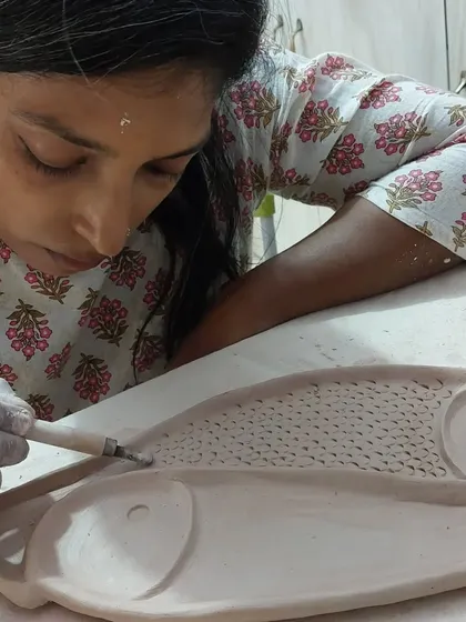 My student Sukanya, a journalist by profession, is seen here carefully carving a fish platter. Our sessions are filled with interesting conversations about everything from music and pets to politics, all while creating with clay.