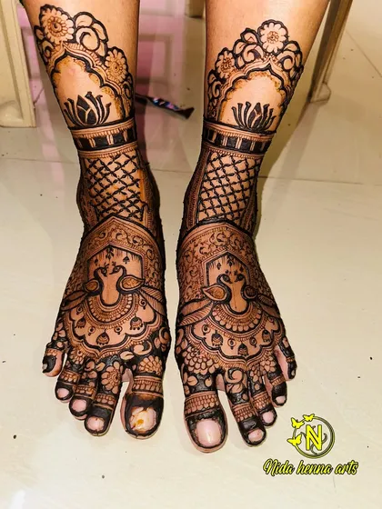 Bridal mehandi isn't complete without beautiful feet. This is an example of my full-coverage foot design, featuring peacock motifs and intricate patterns that match the grandeur of the hand mehandi.