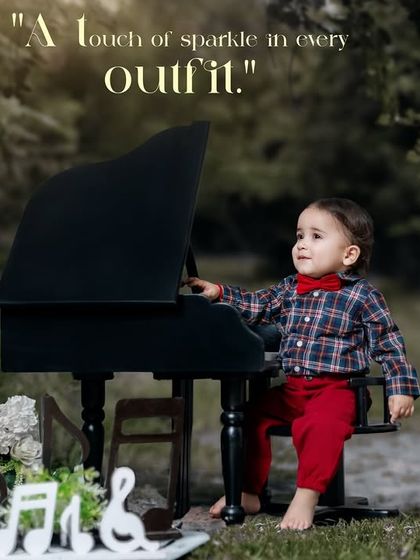 A touch of sparkle in every outfit. A boy in a plaid shirt and red pants looks thoughtfully at his mini piano.