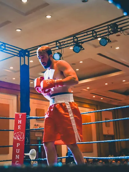 Standing ready in the ring. This image captures the focus and preparation that goes into every single fight.