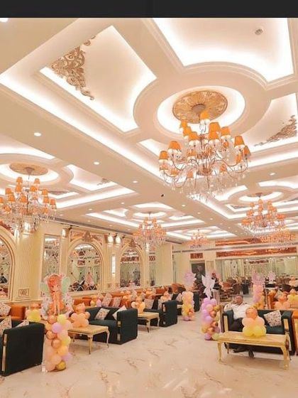 A wide view of the banquet hall, showing how I used balloon pillars to decorate the entire space and match the main stage theme.