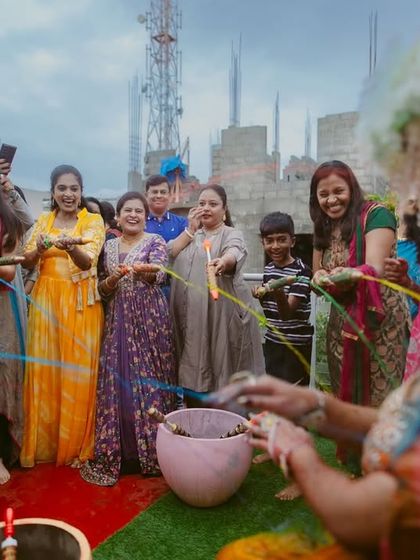 The fun and games of a pre-wedding ceremony. Family and friends join in, spraying colorful strings in a moment of shared joy.