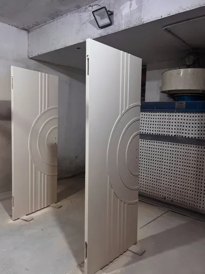 Custom doors being prepared in our paint booth. The concentric circle design adds a modern, graphic element, and our in-house finishing ensures a flawless result.