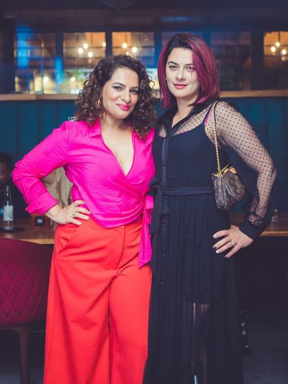 Two stylishly dressed guests at the Valentine's party.