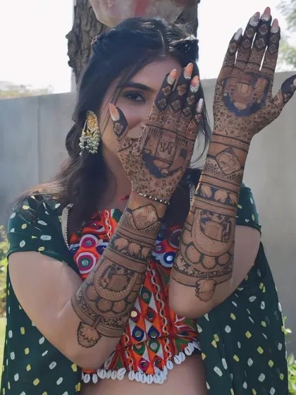 A playful shot from my mehndi ceremony, showing off the intricate designs that cover both my hands and arms.