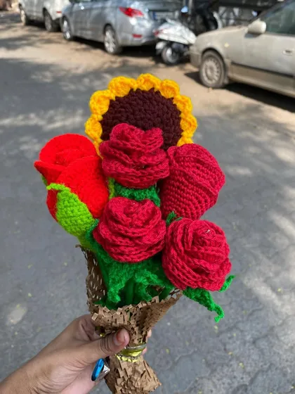 Another angle of the red rose and sunflower bouquet, showing the rich colors and textures of the crochet flowers.
