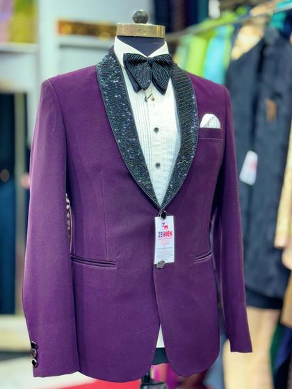 A front view of the purple tuxedo with a sequined lapel. The crisp white pocket square adds a classic finishing touch.