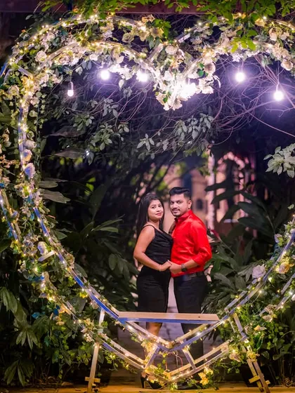 Posing inside the heart-shaped light prop, this couple's photo is a perfect declaration of their love.