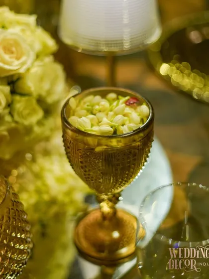 A detail shot of a vintage-style amber glass filled with fragrant jasmine buds. It's these small, sensory details that make an event memorable.