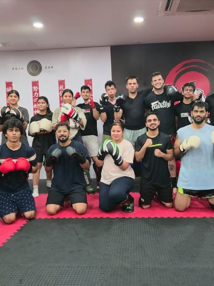 The full class poses after an amazing session with one of our expert coaches. The mix of beginners and experienced students shows our welcoming environment.