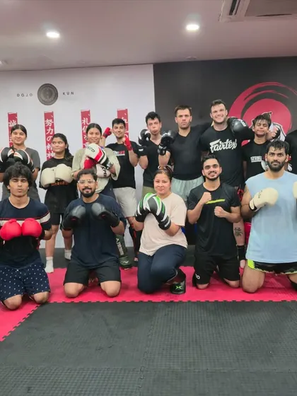 The full class poses after an amazing session with one of our expert coaches. The mix of beginners and experienced students shows our welcoming environment.