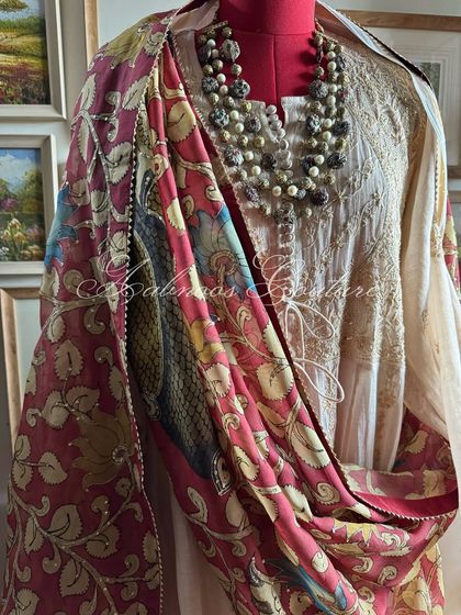 A side view of the mannequin, highlighting the rich colors and peacock motifs of the Kalamkari dupatta.