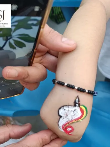 A magical unicorn tattoo being applied at a themed party. Our professional face and body artists can create designs to match any theme, adding a touch of sparkle and fun.