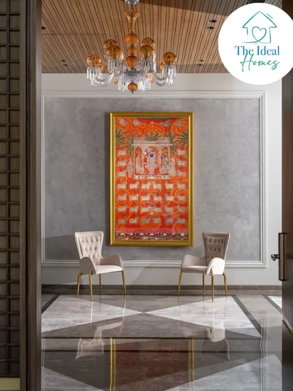 Art is not an afterthought; it is integral to the soul of a home. Here, a traditional Pichwai painting becomes the focal point of the entrance, its vibrant colors enhanced by a crystal chandelier and set against a textured wall. We take pride in weaving our clients' stories and heritage into the very fabric of their homes.