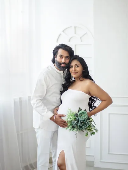 Simple, elegant, and full of love. This portrait uses a minimalist white backdrop to keep the focus entirely on you and your beautiful bump.