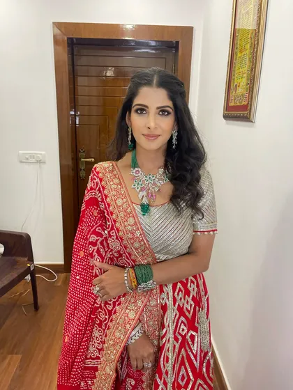 She looks absolutely radiant. The makeup enhances her natural features and pairs beautifully with her stunning jewelry and outfit.