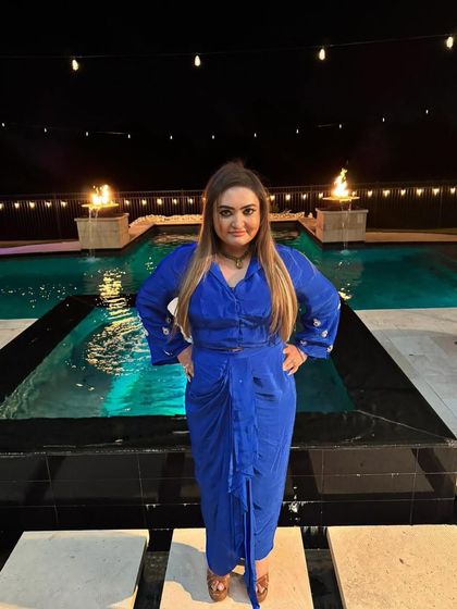 This client is rocking a custom-made royal blue draped dress, looking powerful and stylish. I love creating fusion pieces that empower you to feel your absolute best.