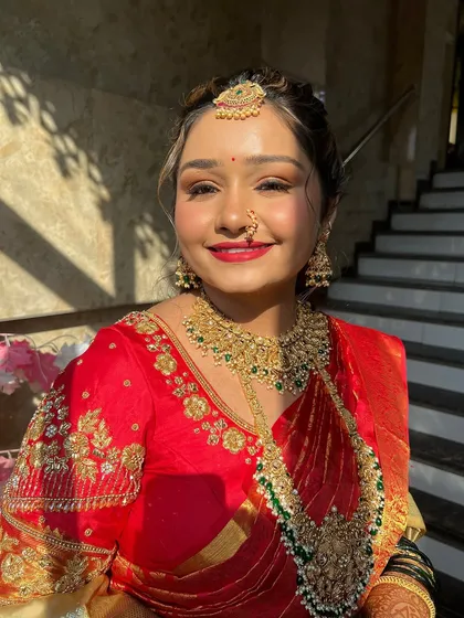 A radiant smile captured in the golden hour light. The makeup is designed to look flawless both in person and on camera.
