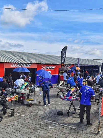 A view of the bustling pit area, where teams prepare their karts for the upcoming sessions.