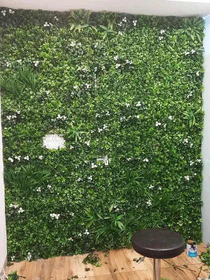An artificial vertical garden installed in a small nook at Radiance Hair Studio in Rajouri Garden. It turns a simple corner into a stylish feature.