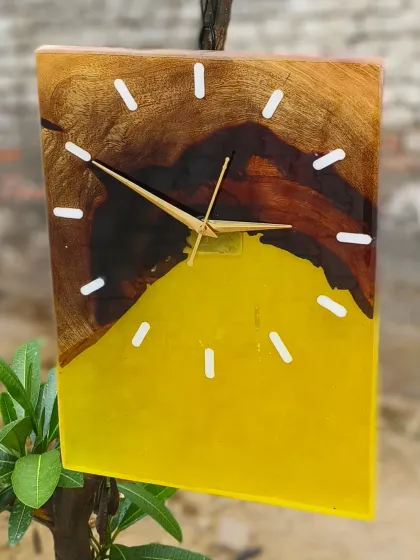 A close-up of the wood and yellow resin clock.