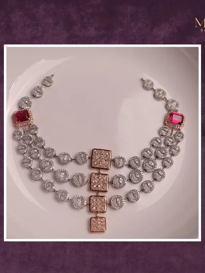 Unveiling a true work of art. This three-layered diamond necklace, accented with rose gold elements and bold ruby squares, is a perfect blend of modern design and classic luxury.