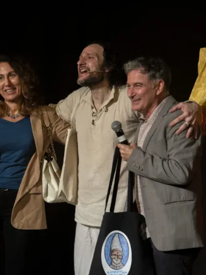 The cast and creators of 'Io, Pulcinella' celebrate a successful performance. The joy and passion for their art are evident.
