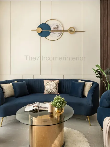 I use color and form to create drama and sophistication. In my 'Royal Mansion' project, this deep blue curved sofa and matching accent chairs are set against a paneled wall with a contemporary art piece, crafting a luxurious and inviting living space.