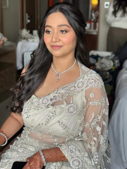 A side profile showing the soft contour and highlight. The look is all about enhancing her natural beauty with a touch of glam.