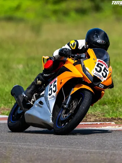 Another look at a rider confidently leaning the bike into a turn at the Aruani Grid. Notice the precise body positioning, which is essential for balance and control during high-speed maneuvers.