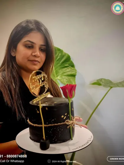 Here I am with one of my favorite elegant designs. This sophisticated black cake is detailed with gold leaf and a single fresh rose, making it perfect for anniversaries or formal celebrations. It shows how a cake can be both a dessert and a work of art.