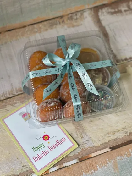 A complete Rakhi gift in one box. This hamper includes my popular mini donuts with dipping sauces, all tied up with a festive ribbon and a 'Happy Raksha Bandhan' card.