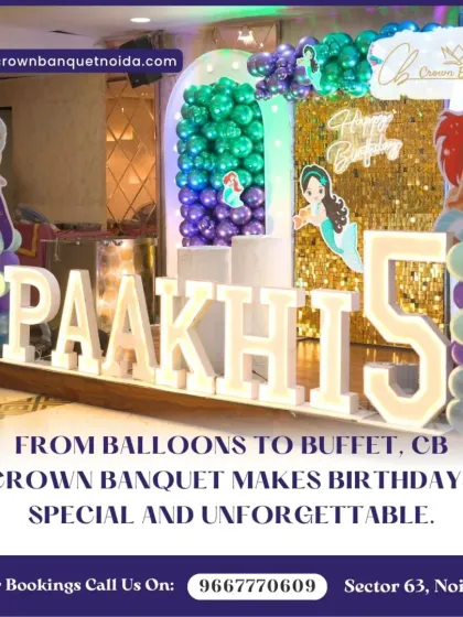 A mermaid-themed fifth birthday decoration. The large light-up name and number, paired with an "under the sea" balloon arch, bring the magical theme to life.
