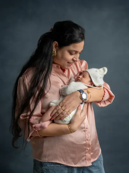 In your arms, they are home. This portrait shows the comfort and security a baby feels when held close by their mother, a bond I love to capture.